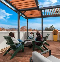 Skydeck lounge with firepit, seating, TV, and bar overlooking Boise and BSU campus