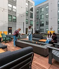 Hot tub courtyard with lounge chairs, shade, and outdoor TVs