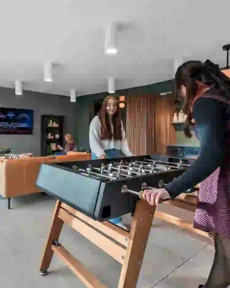 Sky Lounge iwth foosball table, lounge seating, and kitchen