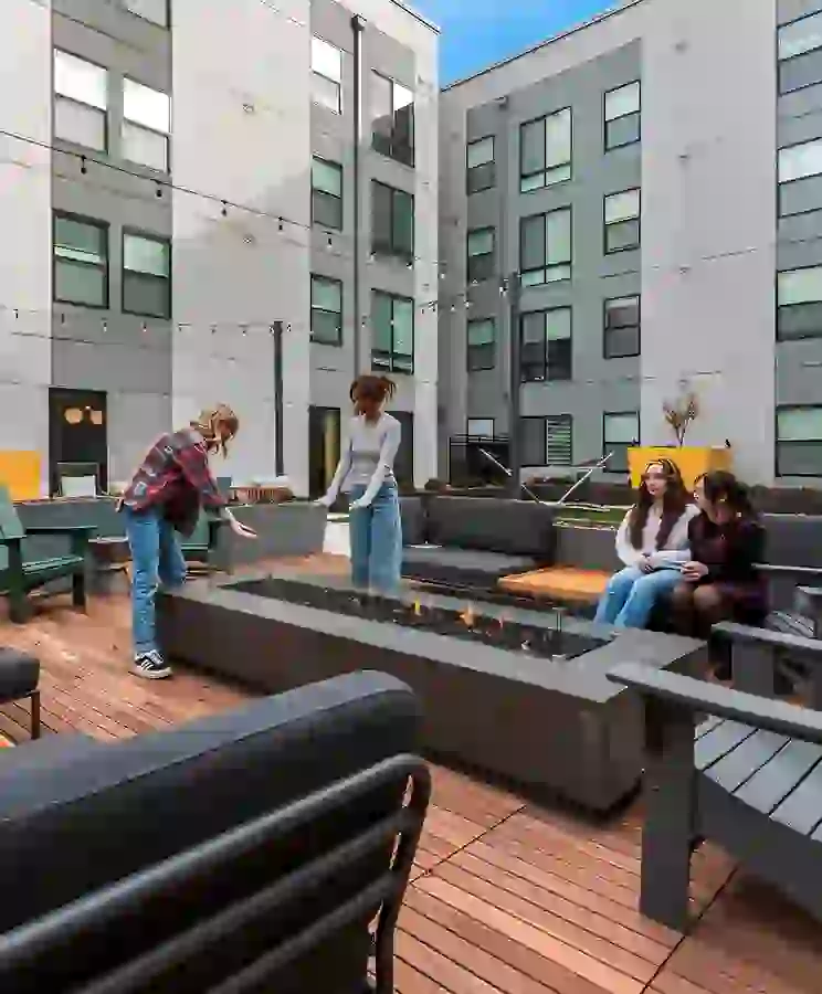 Courtyard with outdoor TV, greenspace, games, grilling, lounge seating, and lush landscaping